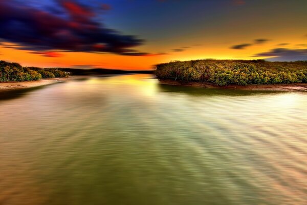 The river at sunset. Island. Beach