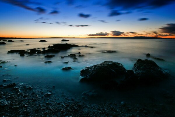 Playa rocosa en el crepúsculo