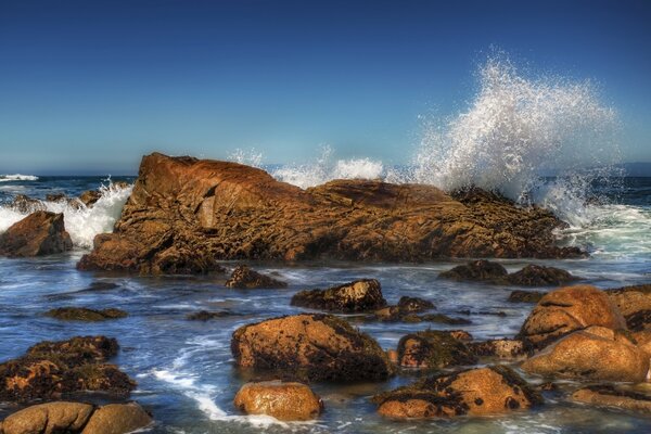 Waves crashing against rocks. Seas