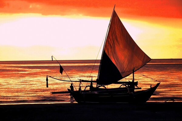 Fishing boat on the background of sunset