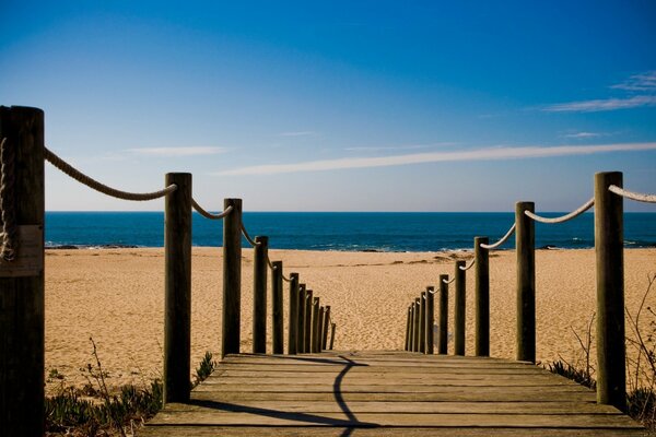 Wooden bridge to the beach and the sea