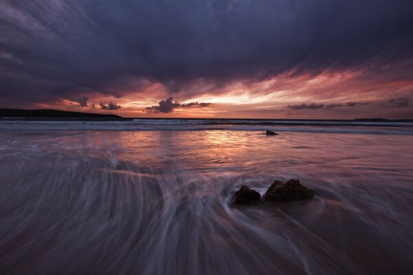 Sunset on a gloomy beach