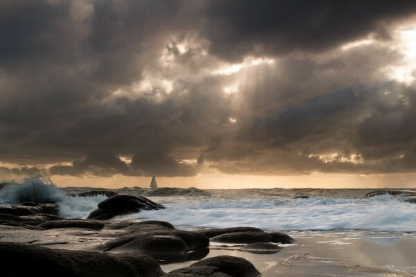 Sea. Heavy clouds. Sailboat