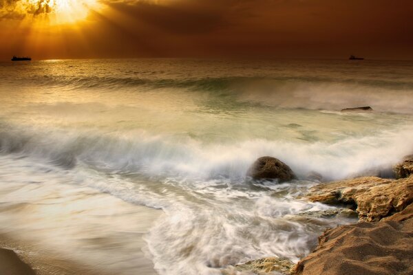 Sunset and waves on the rocky coast