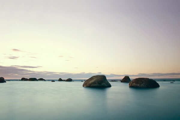 Calm sea against the background of rocks and sky