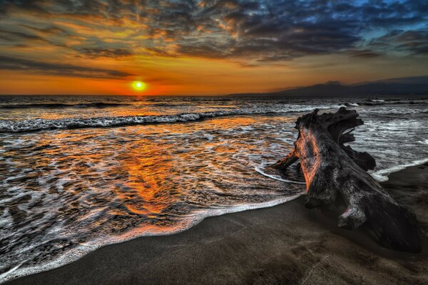 A shimmering sunset makes its way through the clouds