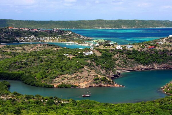 A sea bay with houses on the background of a clear blue sky