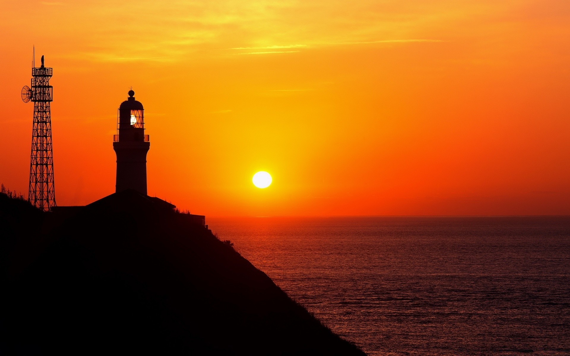 sea and ocean sunset dawn lighthouse evening sun dusk sea ocean water silhouette light backlit beach sky seashore landscape seascape