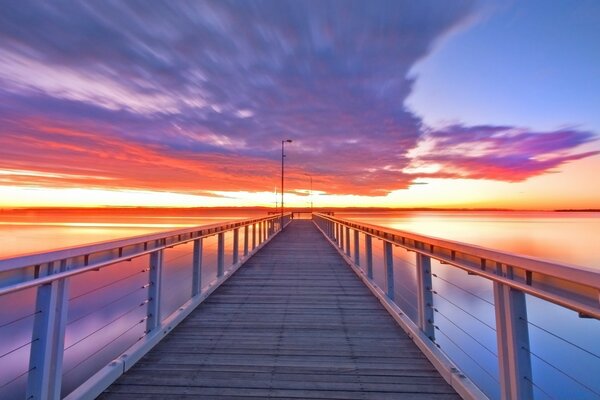 The gloomy bridge on the pier of the sea