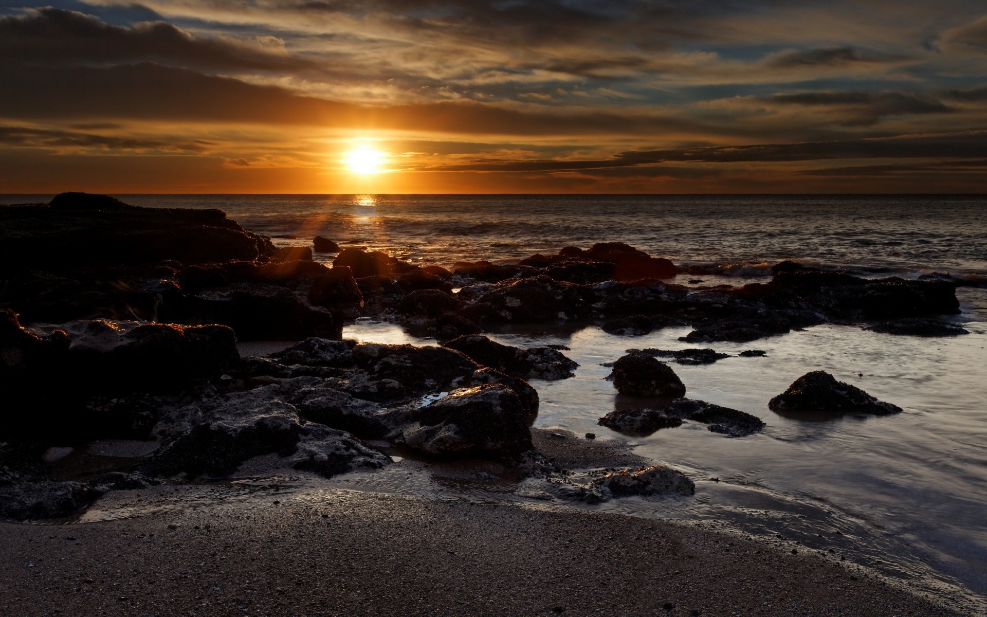 sea and ocean sunset beach water sea dusk dawn ocean evening seashore seascape sun landscape sky surf sand rock fair weather travel