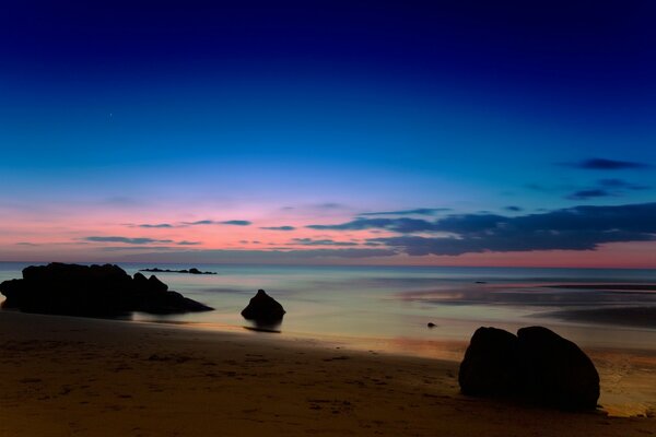 Evening beach of the sea in the rays of sunset