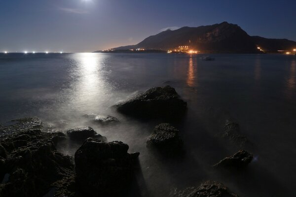 Sea at night, moonlight path on the water