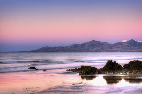 Rocky ocean shore at sunset