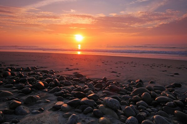 Sunset on the sea beach and reflection in the water