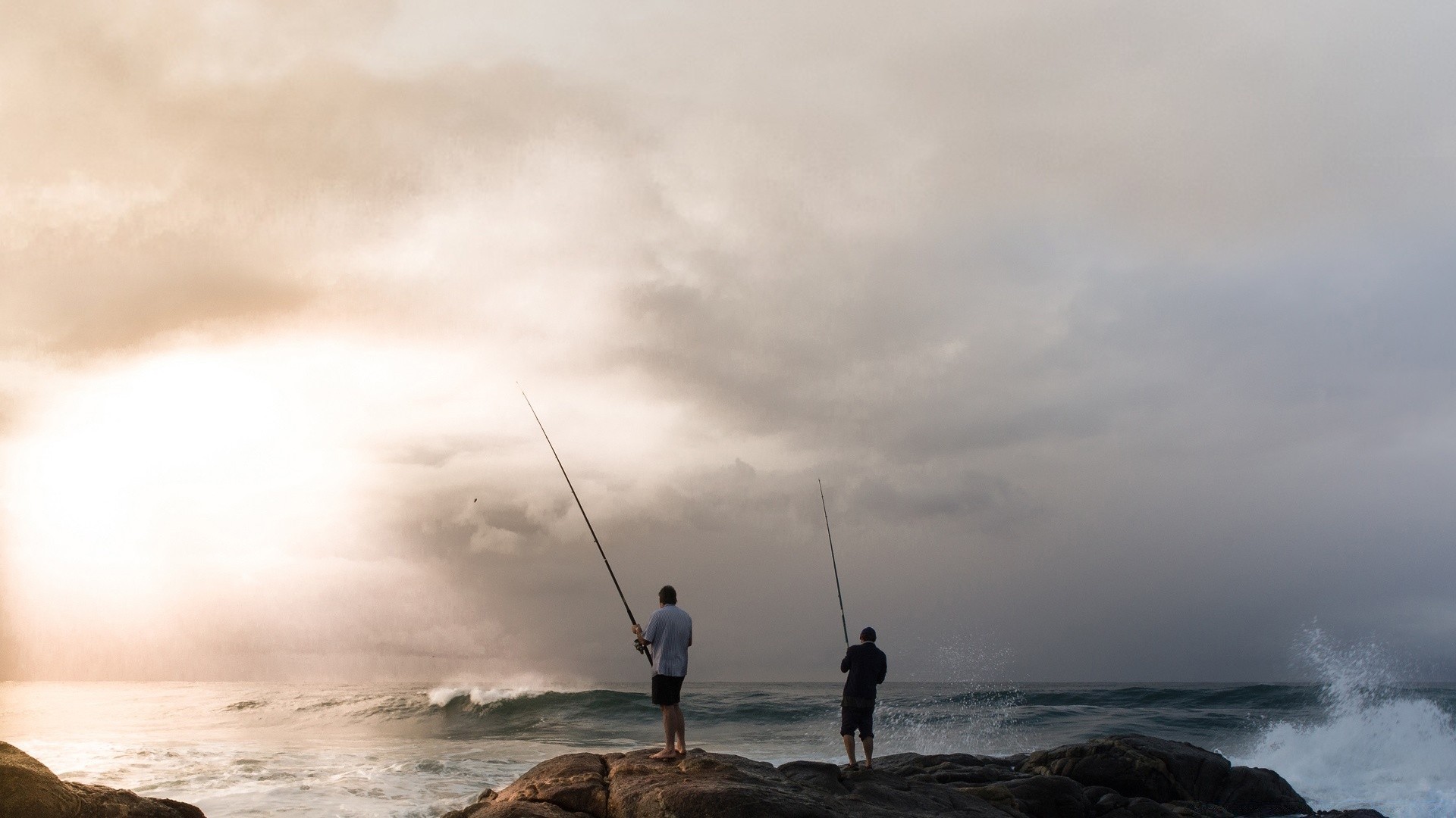 sea and ocean beach sea water ocean fisherman sunset seashore sky storm landscape dawn recreation wave surf leisure fishing rod sun seascape