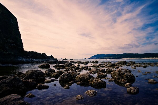 Rocky beach on the sea in the evening