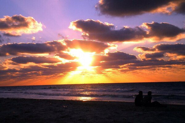 The last ray of the sun on the background of the sea