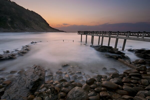 A bridge across the sea on the beach