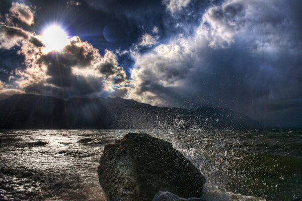 Splashes of ocean waves through the sun s rays