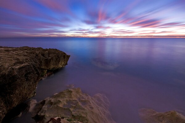 Lilac and gray sky over the sea view from the cliff