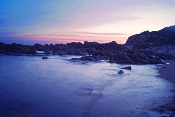 Landscape of ocean , rocks and sunset