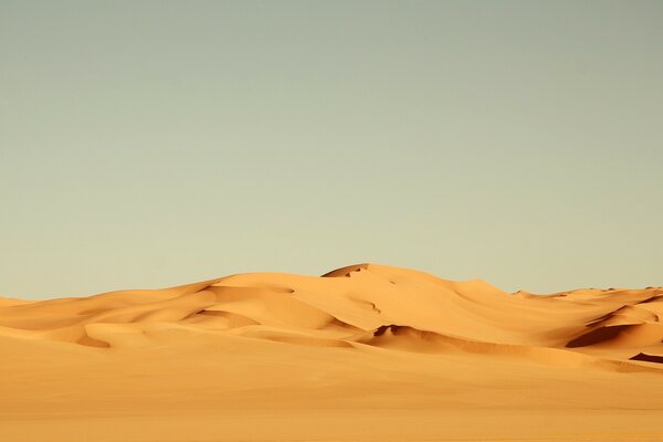 A barren desert with sand dunes