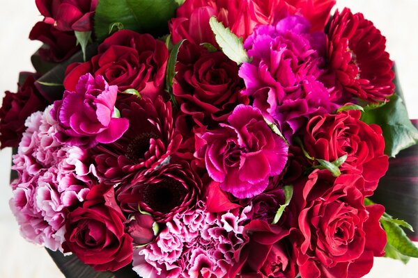 A bright bouquet of red and pink flowers