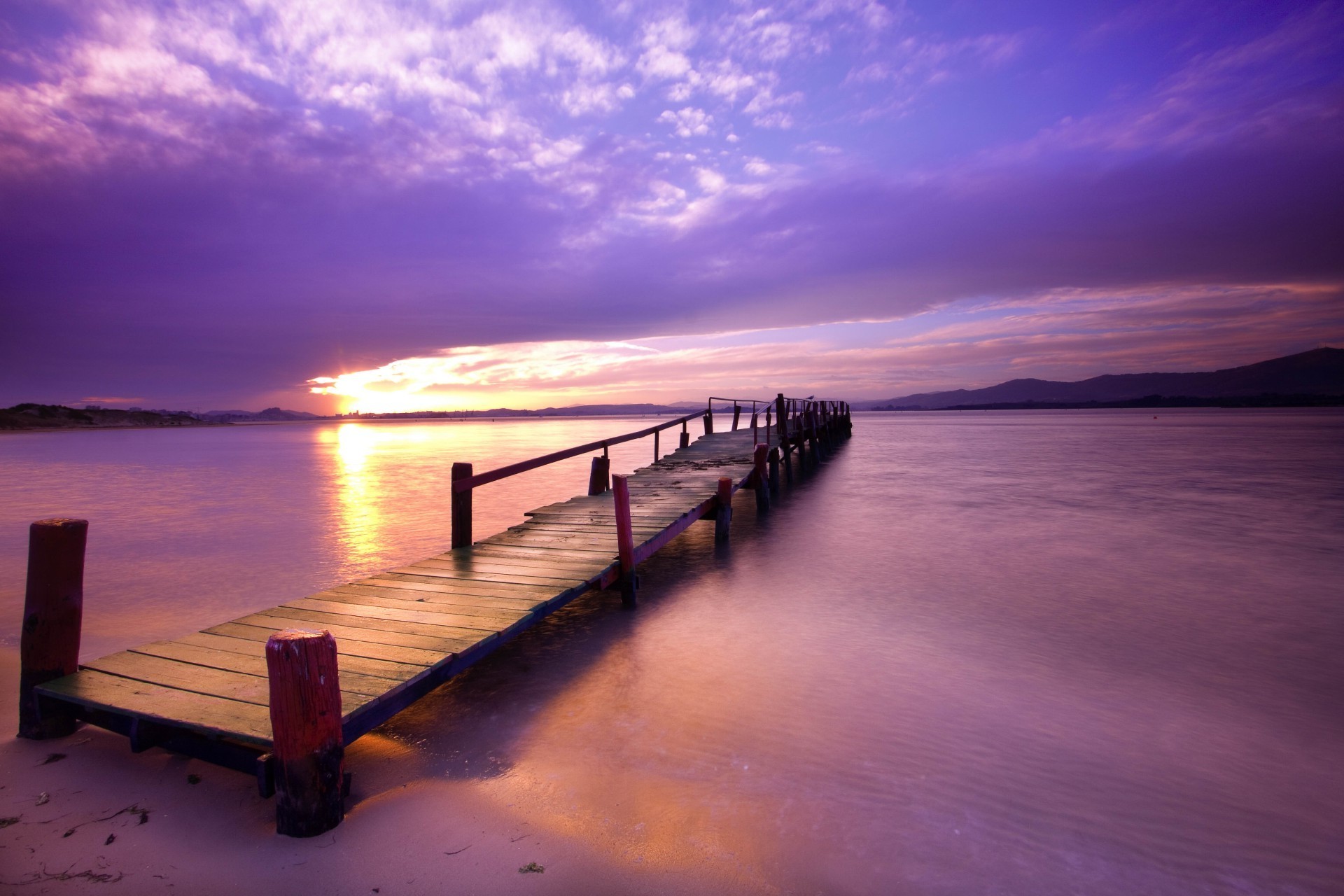 the sunset and sunrise sunset dawn water beach sun pier ocean sea jetty dusk seascape evening boardwalk sky travel summer seashore sand composure