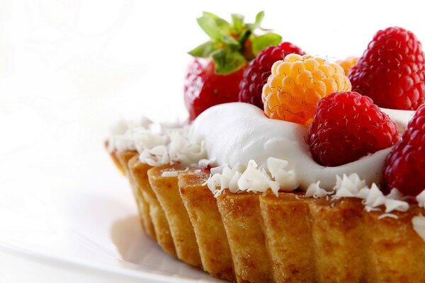 Airy delicate dessert with light cream and berries, sprinkled with coconut chips