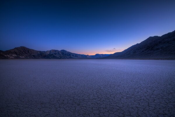 Sunset in the distance at the foot of the mountains