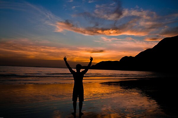 A man at sunset on the beach