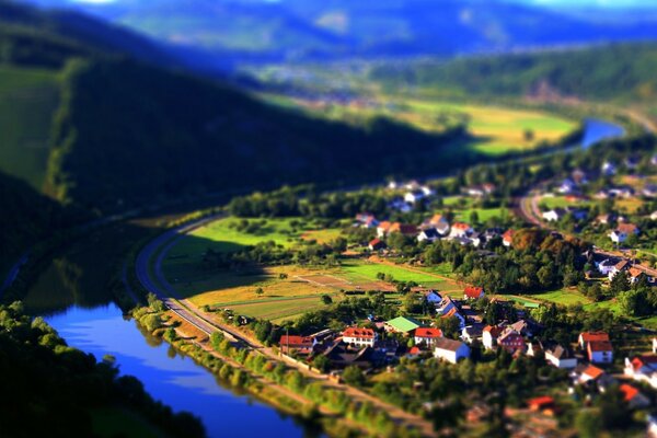 Red roofs of houses from above in the floodplain of the river