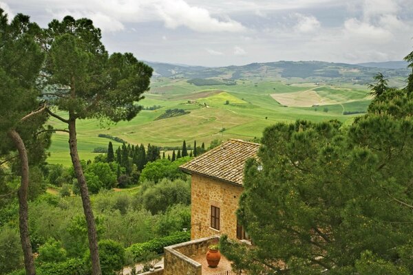 A lonely house in a valley with fields