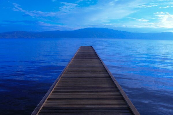 Uma ponte que se estende até um lago