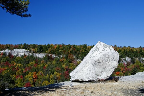 A white boulder against a blue sky