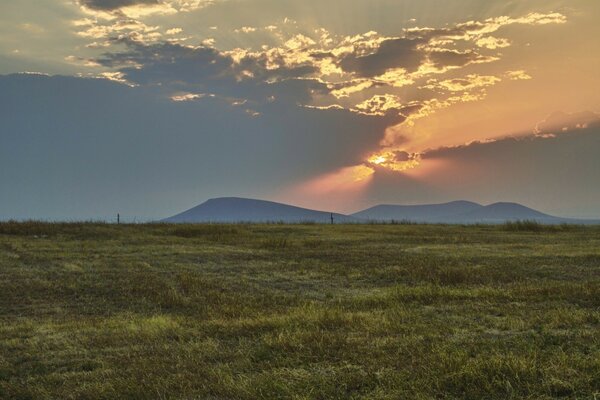 Sunset behind the hills in the endless steppe