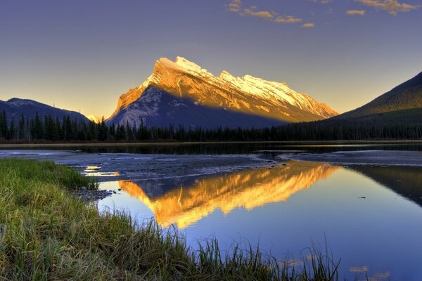 Reflection of the mountains in the lake at dawn