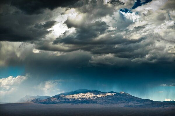 Storm clouds gather over the mountain