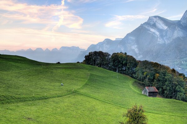 Green hills next to mountains