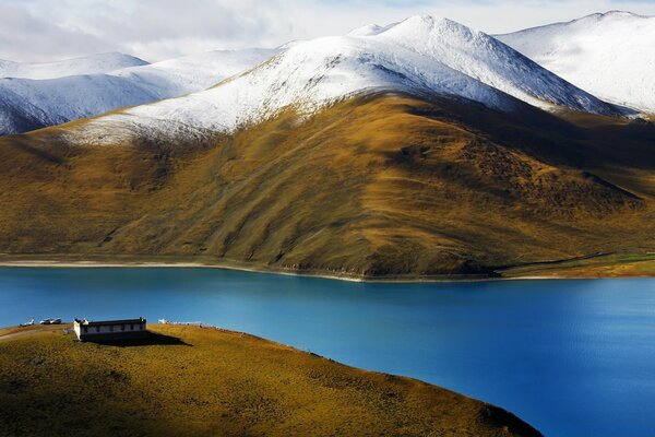 Gentle snow on the smooth mountains near the matte river