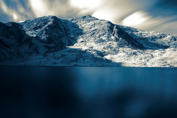 Snow-capped mountains on the lake shore