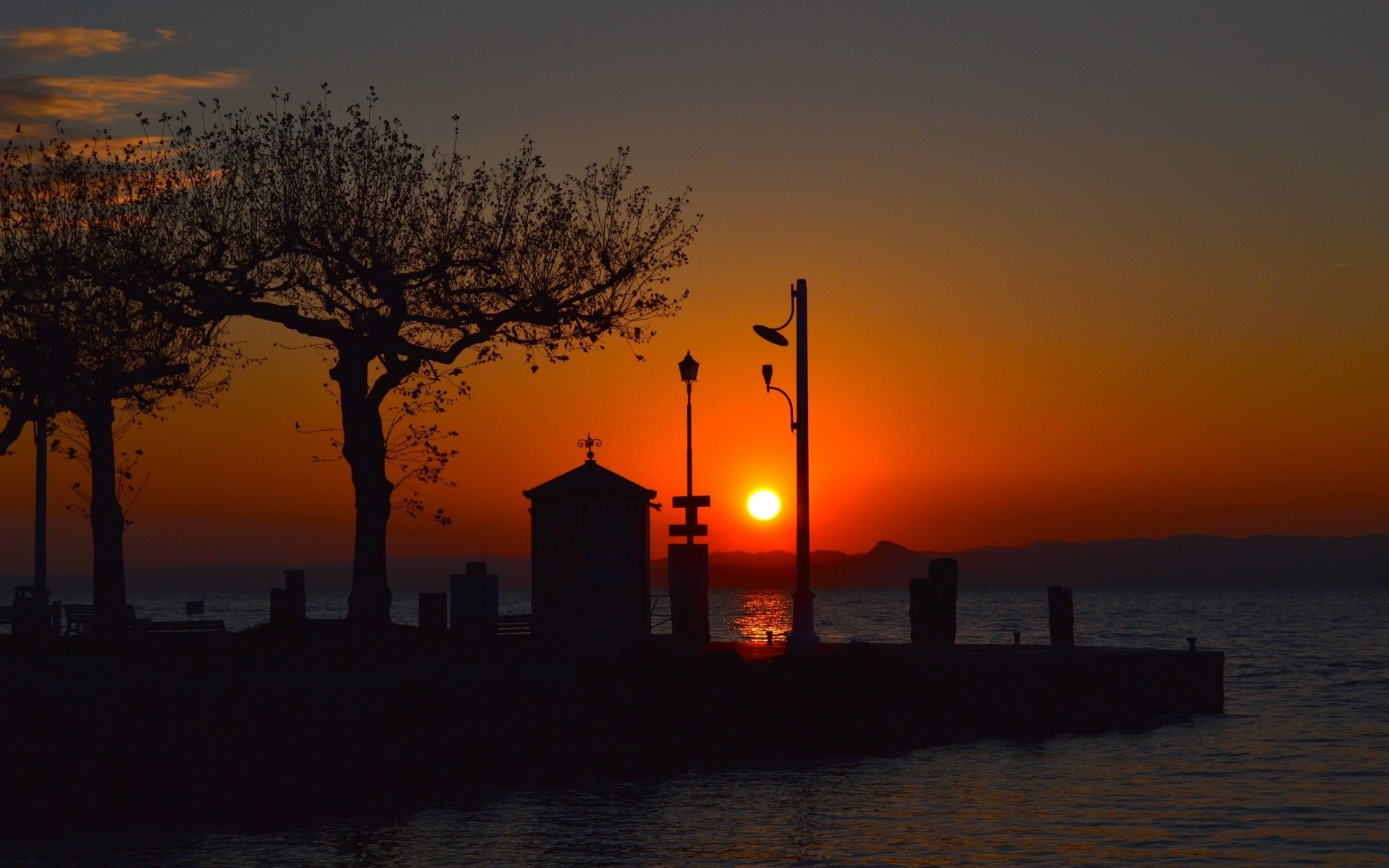 lake sunset dawn evening water dusk silhouette sea sun sky light backlit lighthouse ocean travel beach