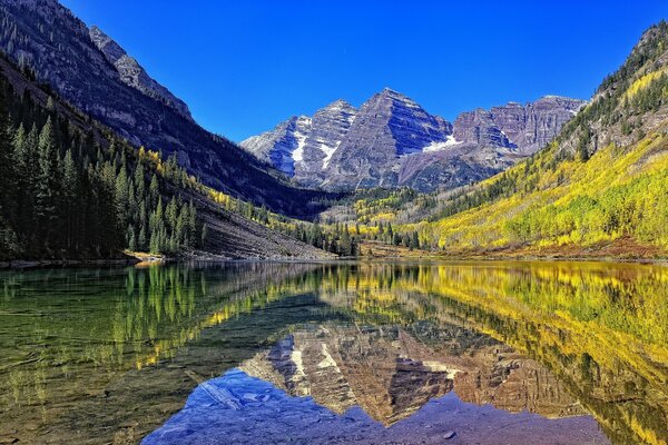 Reflejo de rocas de montaña en el lago