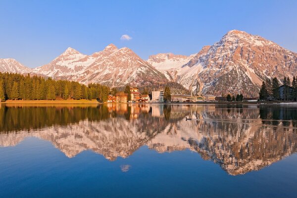 Reflection of mountains in the lake surface winter day