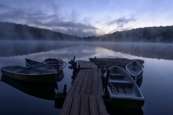 Wooden boats in the semi-darkness on the water