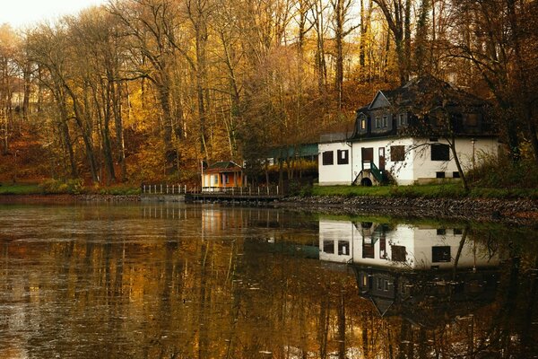 White house by the lake in autumn