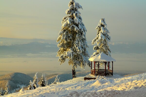 Gazebo on the slope in winter. Mountains