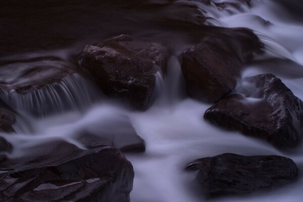 A gloomy stream with slippery rocks