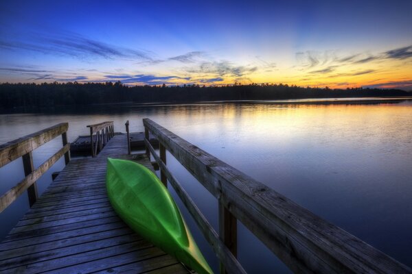 A lonely boat on the pier of the water surface