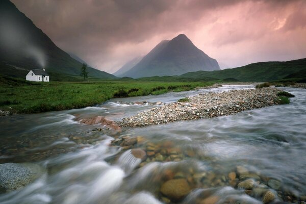 A rocky river flows in the mountains